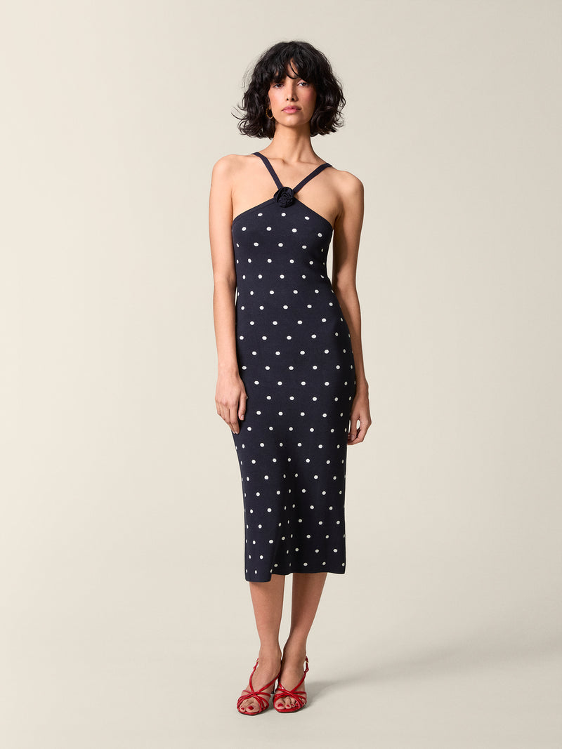 Full front view of the navy polka-dot Laetitia dress.