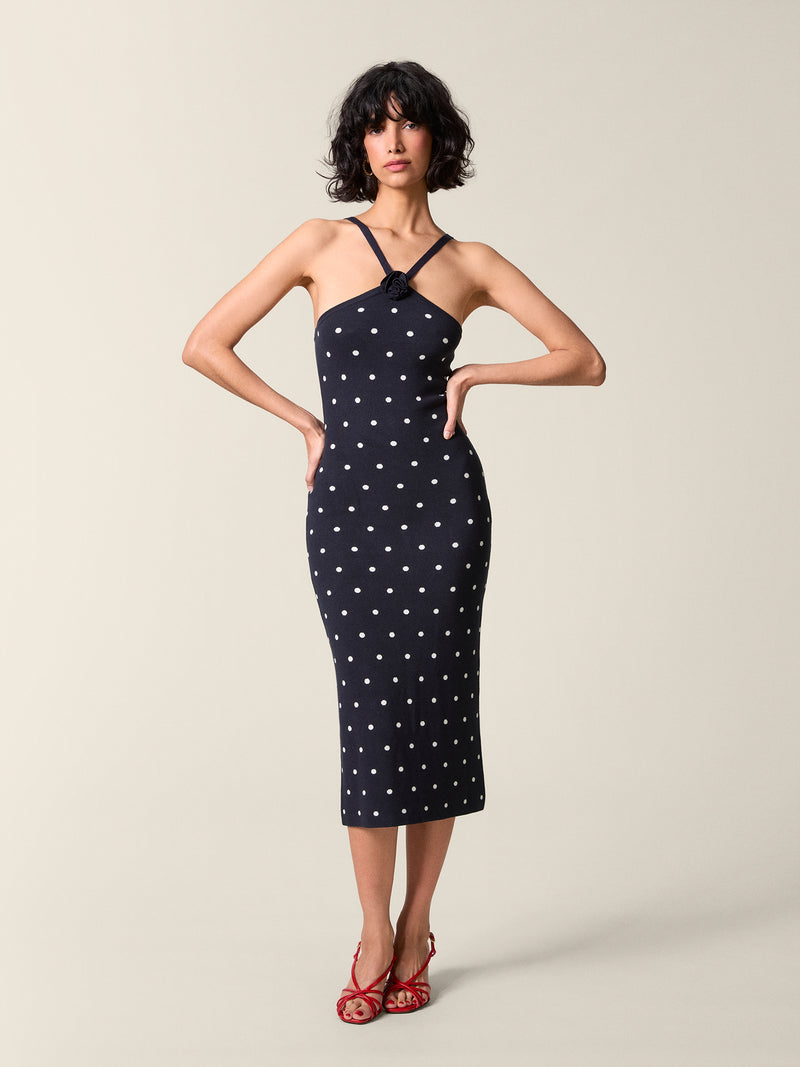 Front view of the navy with white polka dots Laetitia dress.