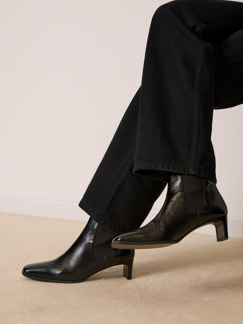 CHELSEA black aged leather ankle boots, back view showing R logo by Rouje